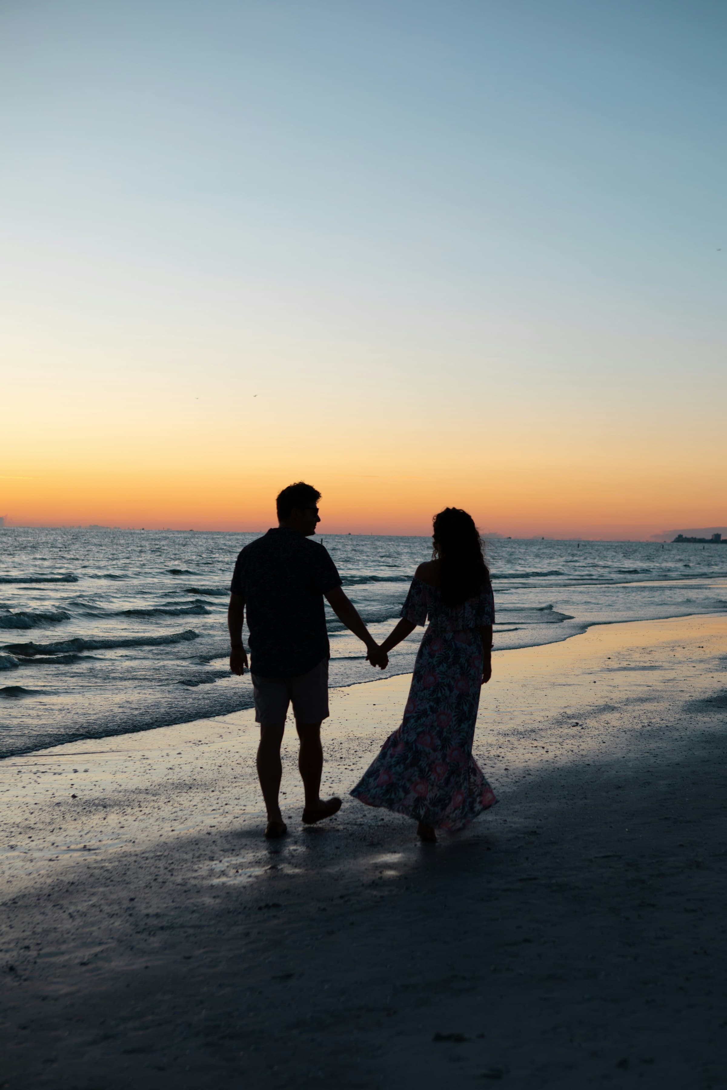 A couple walking hand in hand at golden hour