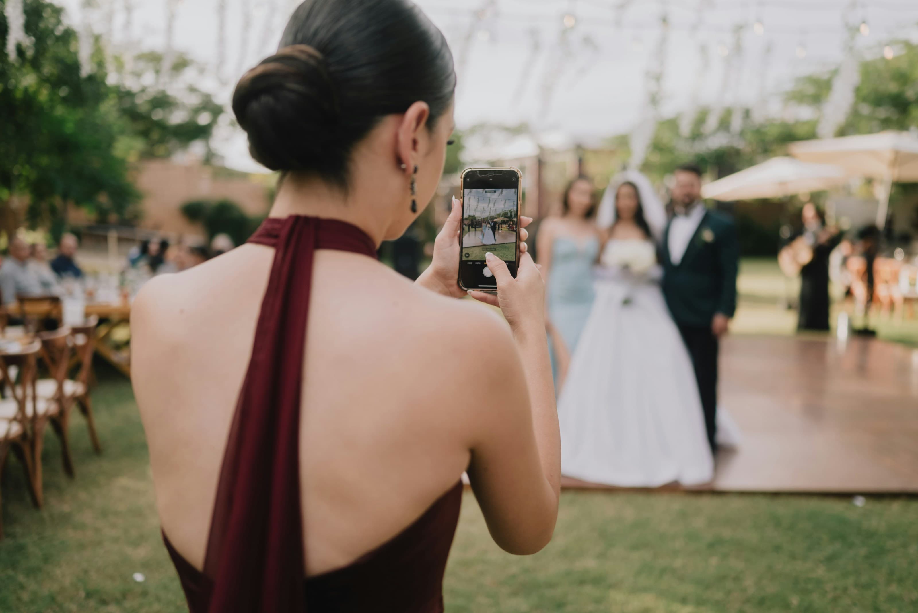 A guest photographing the couple's entrance on her phone